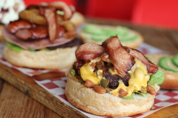 A mouthwatering depiction of hearty burgers featuring crispy bacon and fresh ingredients, ideal for satisfying cravings and showcasing beloved comfort food in a delightful way.