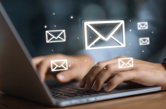 New email notification alerts concept for Digital marketing business communication through virtual inbox and internet technology as Business people use laptop with emails on a virtual screen