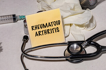 Rheumatoid Arthritis on Sticky Note, Set on the Desk – Medical Concept