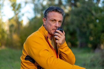 Male hiker using communication device in wilderness