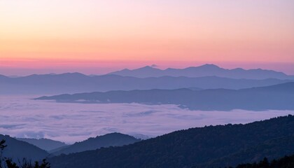 Fototapeta premium Sunrise light shining over misty mountain hills and valleys