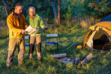 Couple planning their outdoor adventure with map in nature