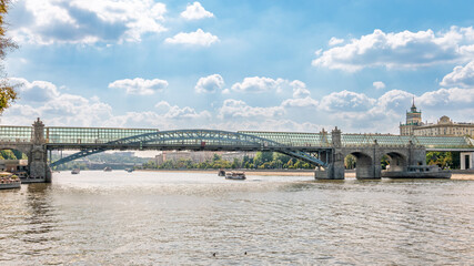Fototapeta premium View of the Moscow river embankment, Pushkinsky bridge and cruise ships at sunset.