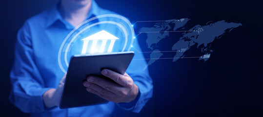 Online digital banking and financial technology concept: A man uses his tablet to access mobile transactions worldwide