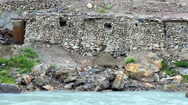 Old villages in Tajikistan. Tajikistan's road along the Zeravshan River near the Pamir highway. Old stone villages in the mountains of the Silk Road. 4К