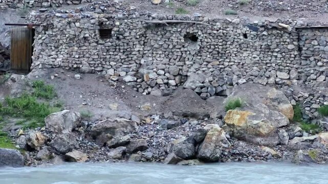Old villages in Tajikistan. Tajikistan's road along the Zeravshan River near the Pamir highway. Old stone villages in the mountains of the Silk Road. 4К