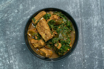 Spicy pork bone curry with betel leaves, a local dish from southern Thailand.