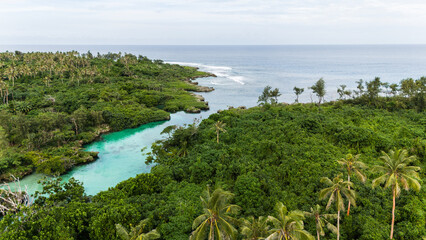 Aerial view where a lagoon meets the ocean.