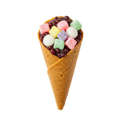 Colorful dessert cone filled with sweet toppings against a plain background