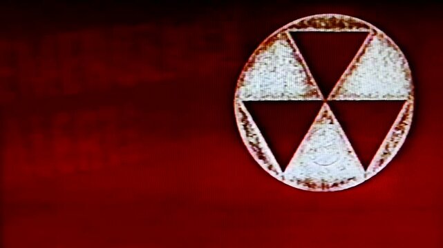 Emergency alert radioactive symbol and retro duck and cover message, processed through videotape for authentic tape damage effect.