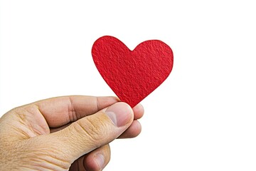 Fototapeta premium A hand holds a small red heart. A simple, heartfelt gesture