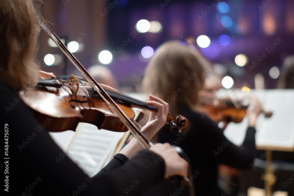 Aufkleber close-up of a musician's hands playing a violin during a live concert performance, capturing the ess