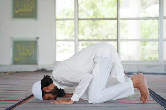 Peaceful sujood: Muslim man prays devoutly in a mosque. Spiritual connection and faith.