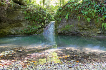 autumn hike to the sources of a mountain river along the riverbed and canyon through difficult wilderness areas