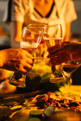 Friends and family enjoy a summer barbecue outdoors, grilling meat and vegetables, laughing, drinking, and celebrating together in the backyard.