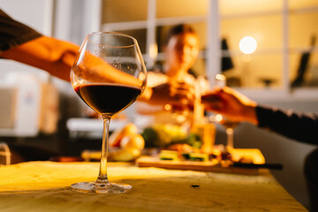 Friends and family enjoy a summer barbecue outdoors, grilling meat and vegetables, laughing, drinking, and celebrating together in the backyard.
