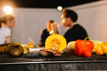 Friends and family enjoy a summer barbecue outdoors, grilling meat and vegetables, laughing, drinking, and celebrating together in the backyard.
