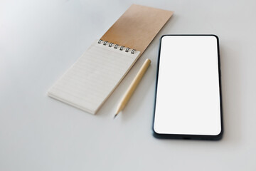copy space with notebook and mobile phone, pencil on white table