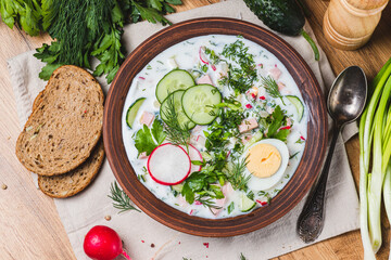 Okroshka on kefir with radishes and herbs