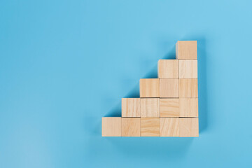 Wooden Block Stair Step on Blue Background for Growth Concept