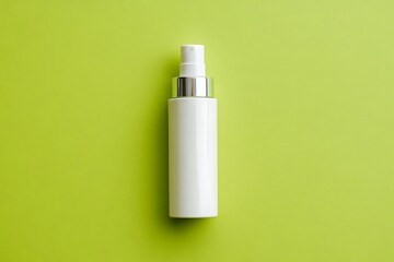 White spray bottle against vibrant green background