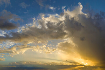 Amazing sunset skyscape. Evening sky with bright colorful orange and yellow clouds