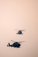 Military helicopter air attack by a squadron during dawn