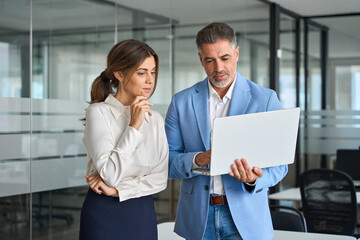 Busy professional team of two middle aged business people company executive leaders managers...