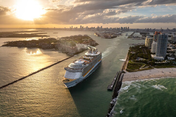 Big passenger cruise liner ship departing at main channel in Miami harbor near South Beach high...