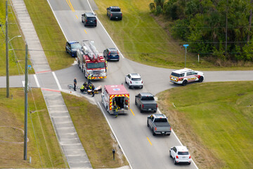 Car crash with first responders helping cyclist who was hit by car at accident site on American...