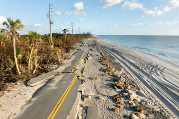Hurricane storm surge destroyed waterfront road on ocean shore in Florida. Severe damage to...