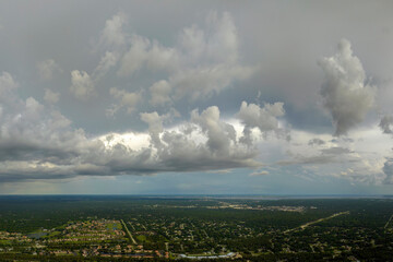 Rainstorm shower over Florida rural town in humid summer season. Rain water pouring down from stormy clouds