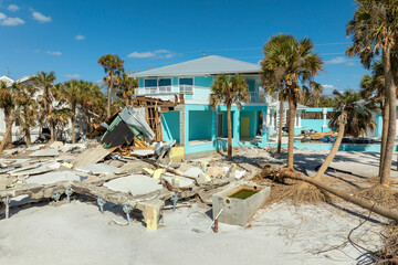 Storm surge caused by hurricane wind severe damaged residential houses on ocean shore. Natural...