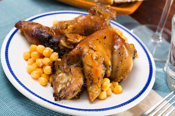 Tasty pork legs with chickpeas closeup