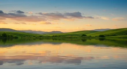 Serene lakeside landscape featuring green hills and reflecting sunset colors website background © Minara
