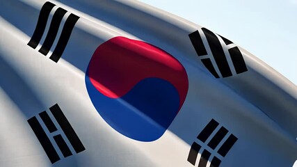 Close-up of the South Korean flag waving under clear blue sky.