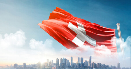 Switzerland national flag waving with skyline and buildings. Switzerland national flag for independence day.