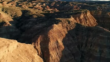 Breathtaking Aerial Vista of Eroded Brown and Red Rock Canyon in Desert Landscape