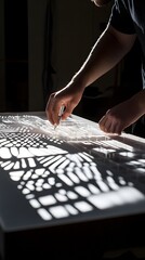 Architect testing shadow patterns with scale model