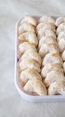 Kue Nastar and Putri Salju (Pineapple Tart and Snow-White Cookie) in a white box and background. Famous delicacy for Lebaran (Eid al-Fitr), Natal (Christmas), and Imlek (Chinese New Year) in Indonesia