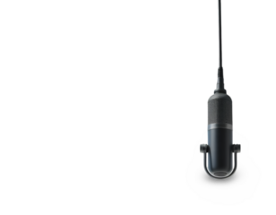 Microphone Hanging Against a Black Backdrop for Audio Recording