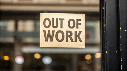 Out of work sign on glass window reflecting city street during great depression time with sense of struggle and economic hardship
