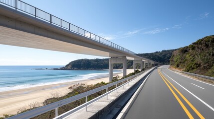 A highway overpass with a railing and a road leading to a beach.