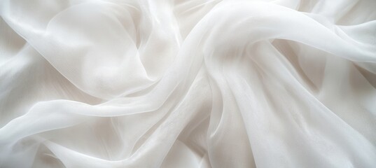 A close-up view of soft. flowing white fabric draped elegantly. showcasing delicate textures and subtle shadows. ideal for backgrounds or fashion-related designs
