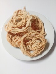 kerupuk mie bulat or round noodle crackers. Medan crackers. round noodle crackers are crackers made from tapioca flour dough with a round shape resembling noodles. fried. dry and crispy snacks.