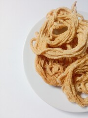 kerupuk mie bulat or round noodle crackers. Medan crackers. round noodle crackers are crackers made from tapioca flour dough with a round shape resembling noodles. fried. dry and crispy snacks.