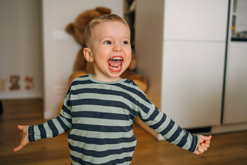 Happy toddler smiling joyfully at home