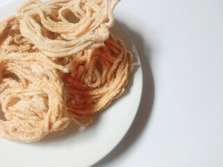 kerupuk mie bulat or round noodle crackers. Medan crackers. round noodle crackers are crackers made from tapioca flour dough with a round shape resembling noodles. fried. dry and crispy snacks.