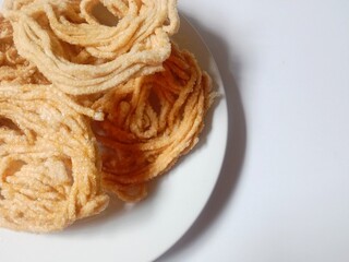 kerupuk mie bulat or round noodle crackers. Medan crackers. round noodle crackers are crackers made from tapioca flour dough with a round shape resembling noodles. fried. dry and crispy snacks.