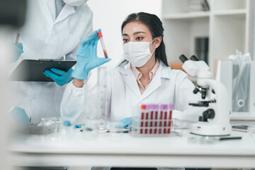 Medical research team conducting health and pharmaceutical experiments using blood samples in laboratory to develop advanced treatments and vaccines for global healthcare innovation